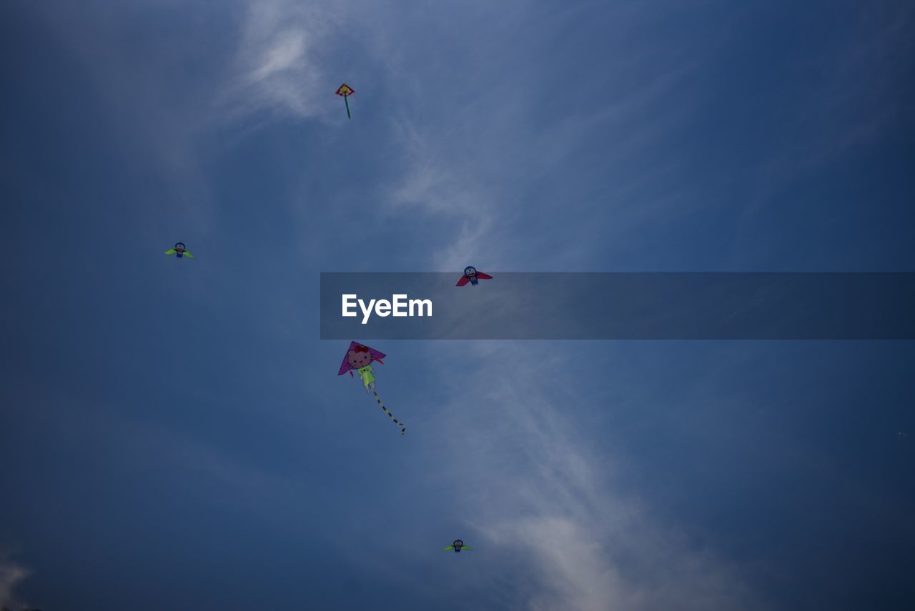 LOW ANGLE VIEW OF KITES FLYING IN SKY