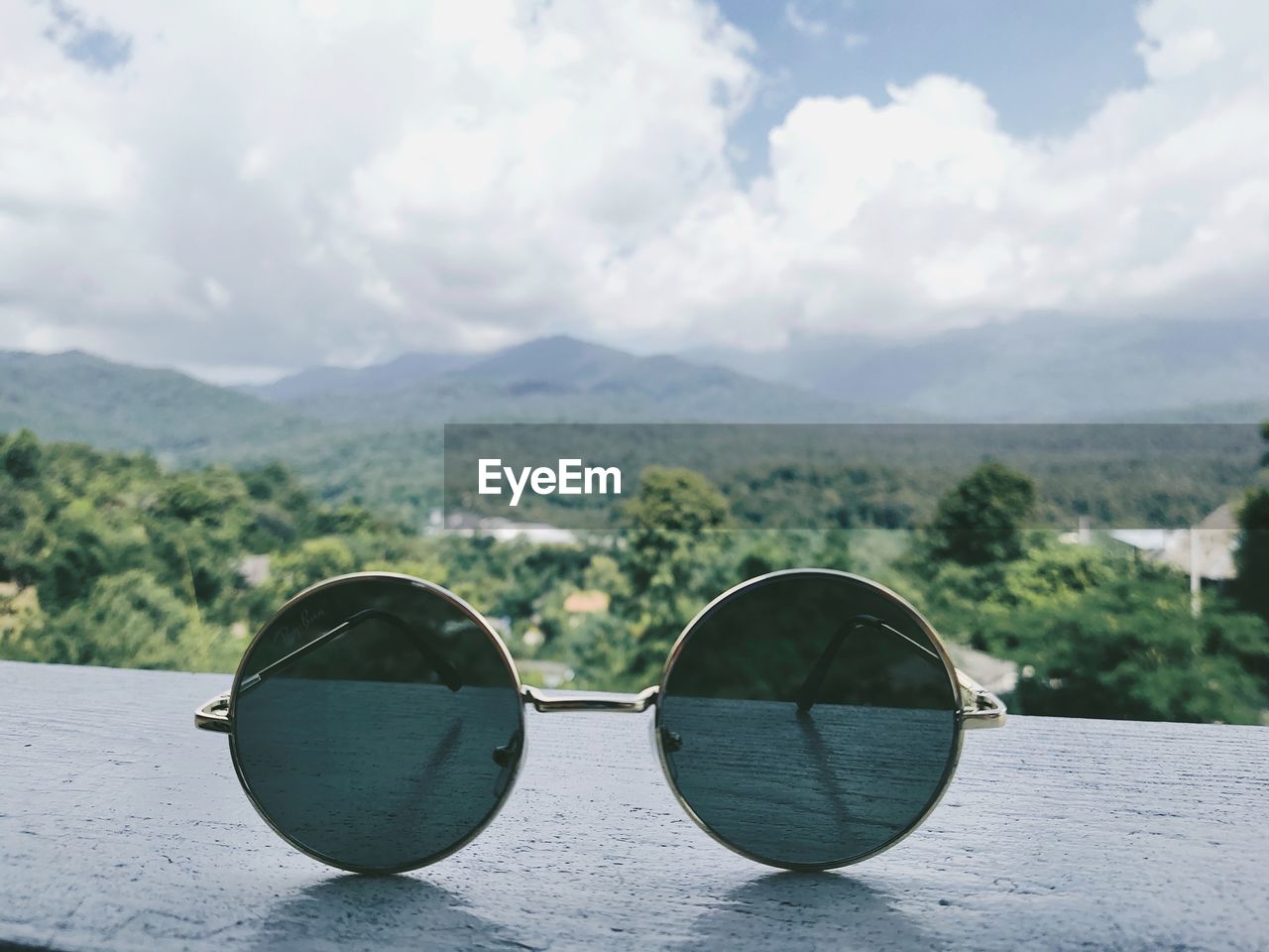 Sunglasses on mountain against sky