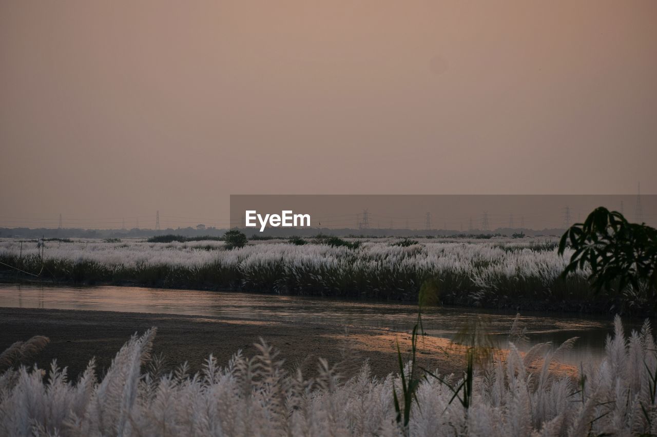 SCENIC VIEW OF LAKE AGAINST SKY DURING SUNSET