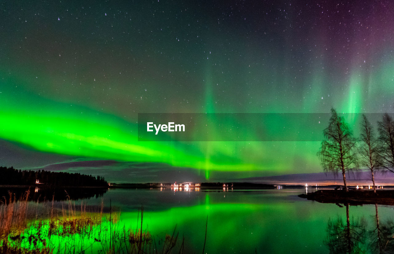 Scenic view of lake against sky at night