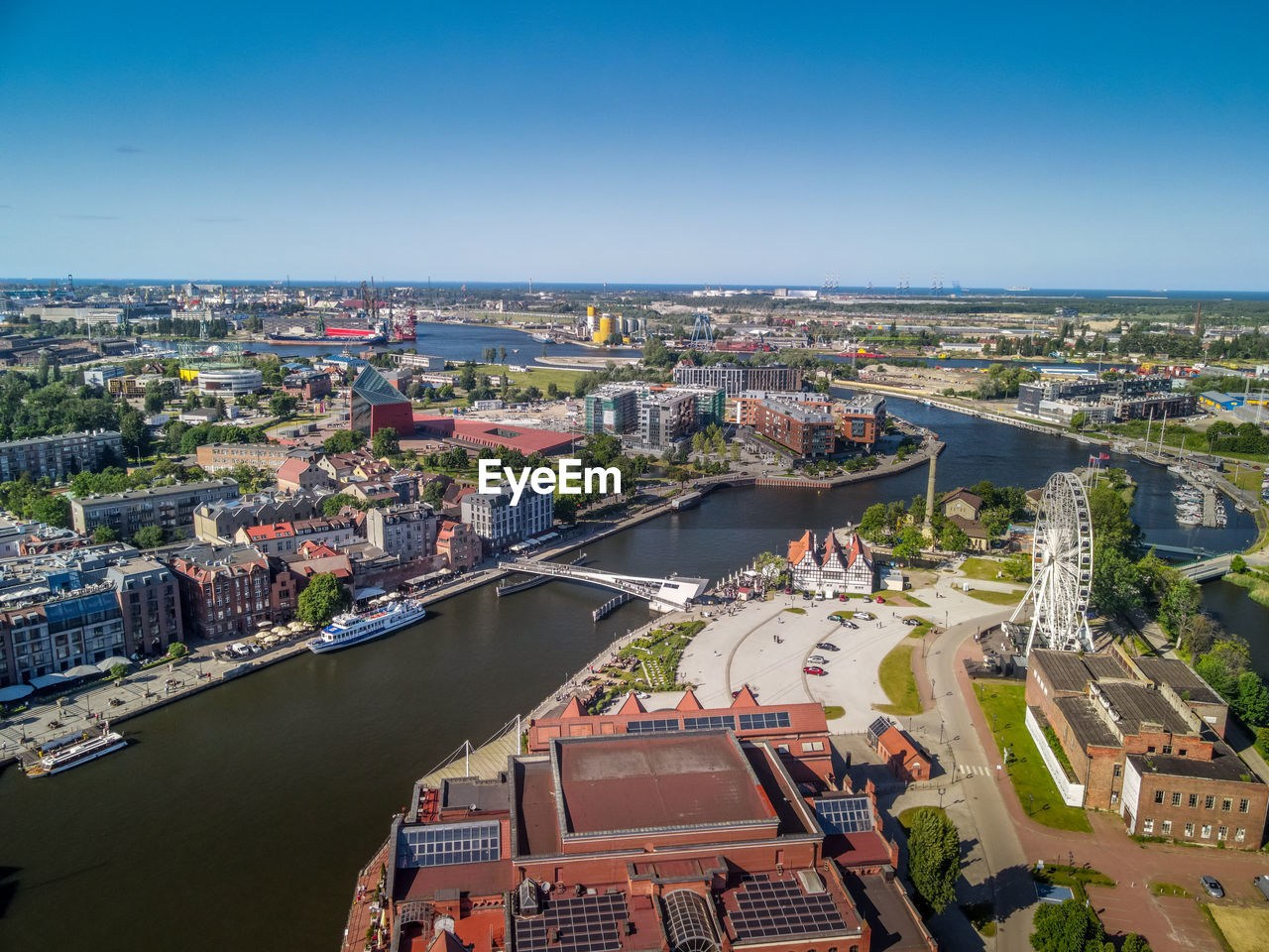 High angle view of the river amidst buildings in town against the sky, gdansk, poland.