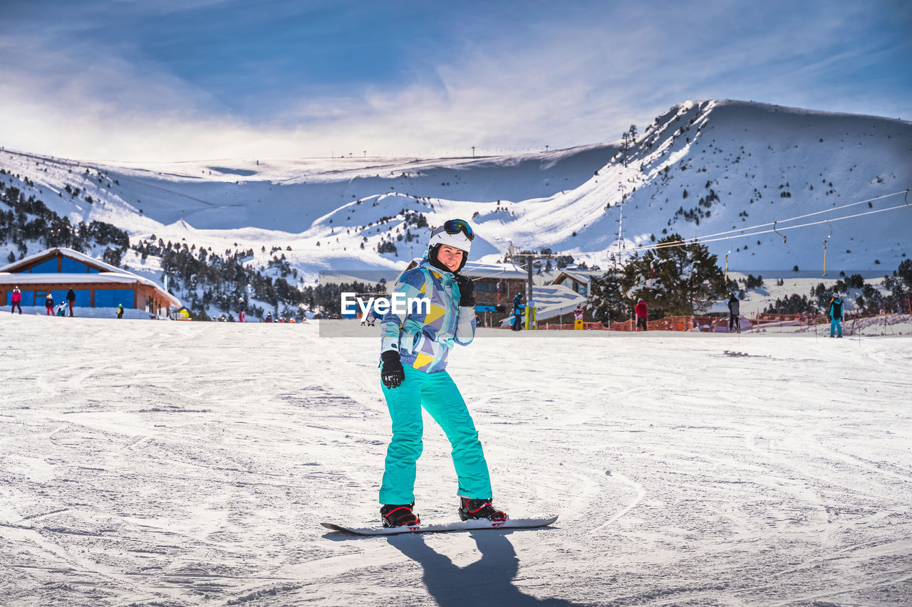 Woman, having fun and learning how to ride on a snowboard, andorra