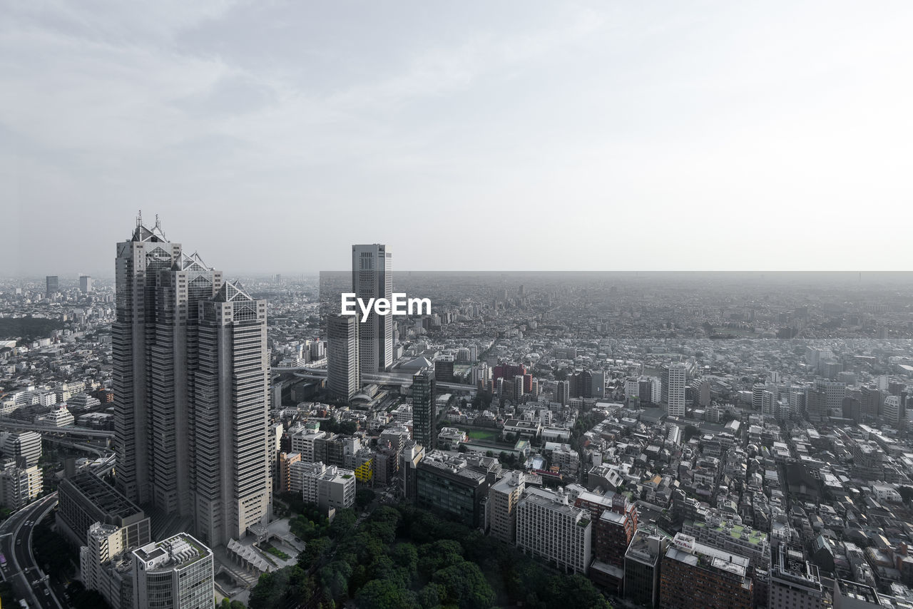 High angle view of modern buildings in city against sky