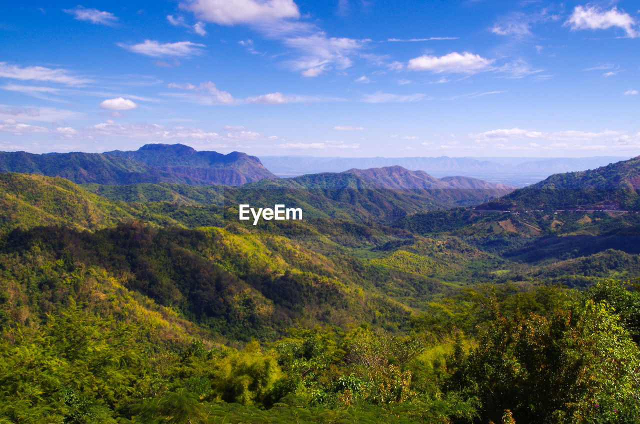 Scenic view of mountains against cloudy sky