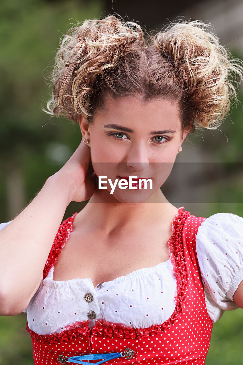 Close-up portrait of young woman wearing dirndl