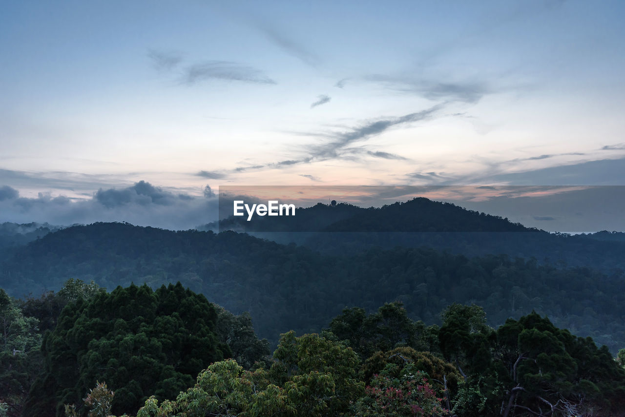 Scenic view of mountains against sky at sunset