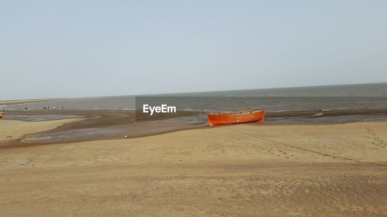 Scenic view of beach against clear sky