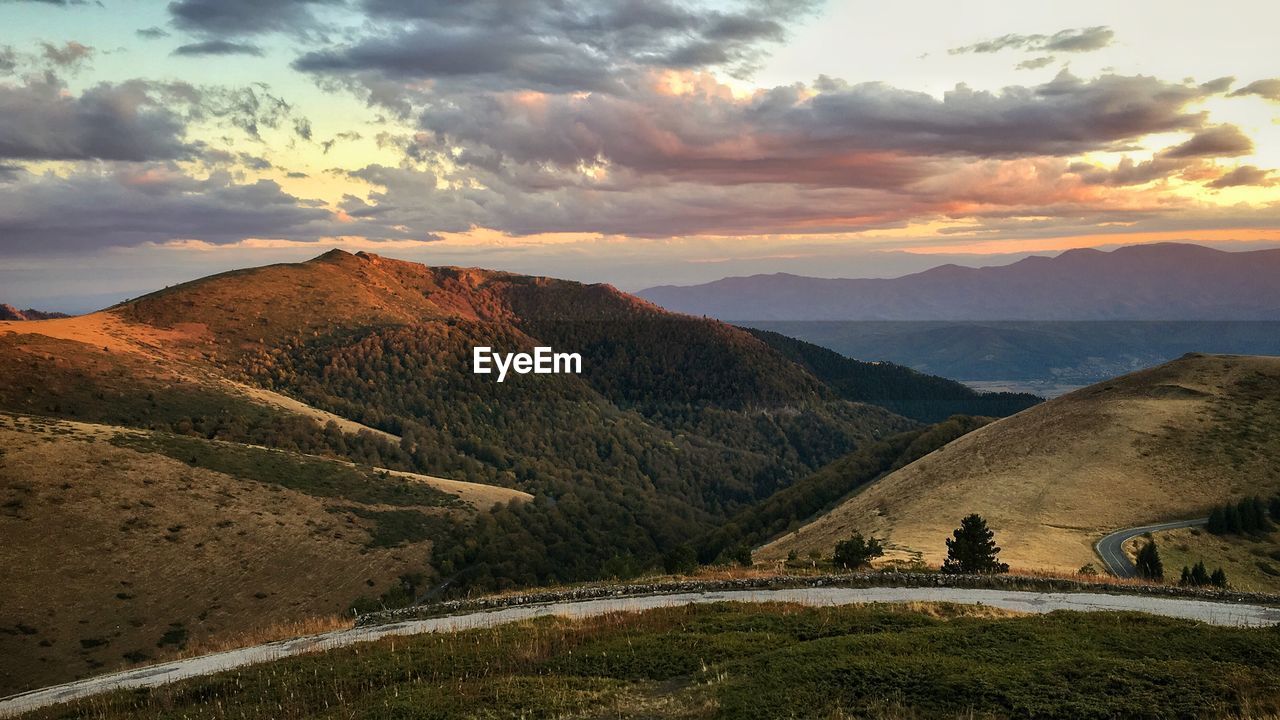 SCENIC VIEW OF MOUNTAIN AGAINST SKY DURING SUNSET