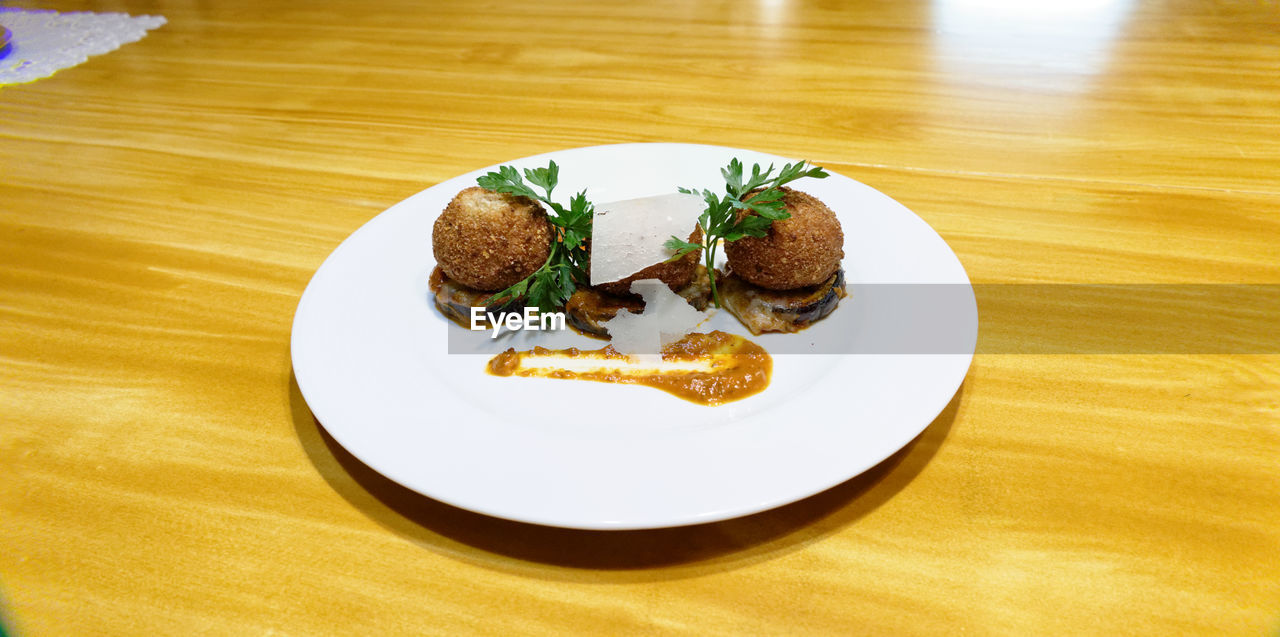 Food served in plate on wooden table