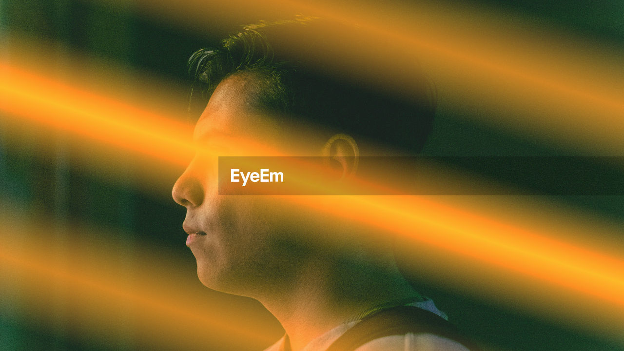 Close-up portrait of young man looking away