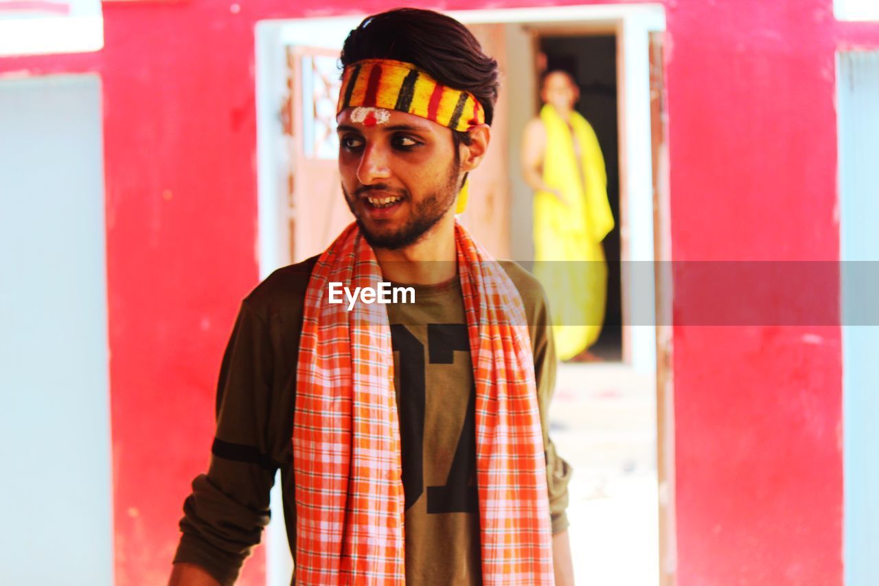 Portrait of smiling young man standing outdoors