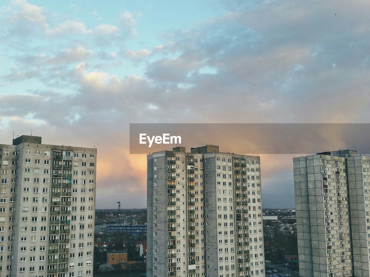 High section of buildings against clouds