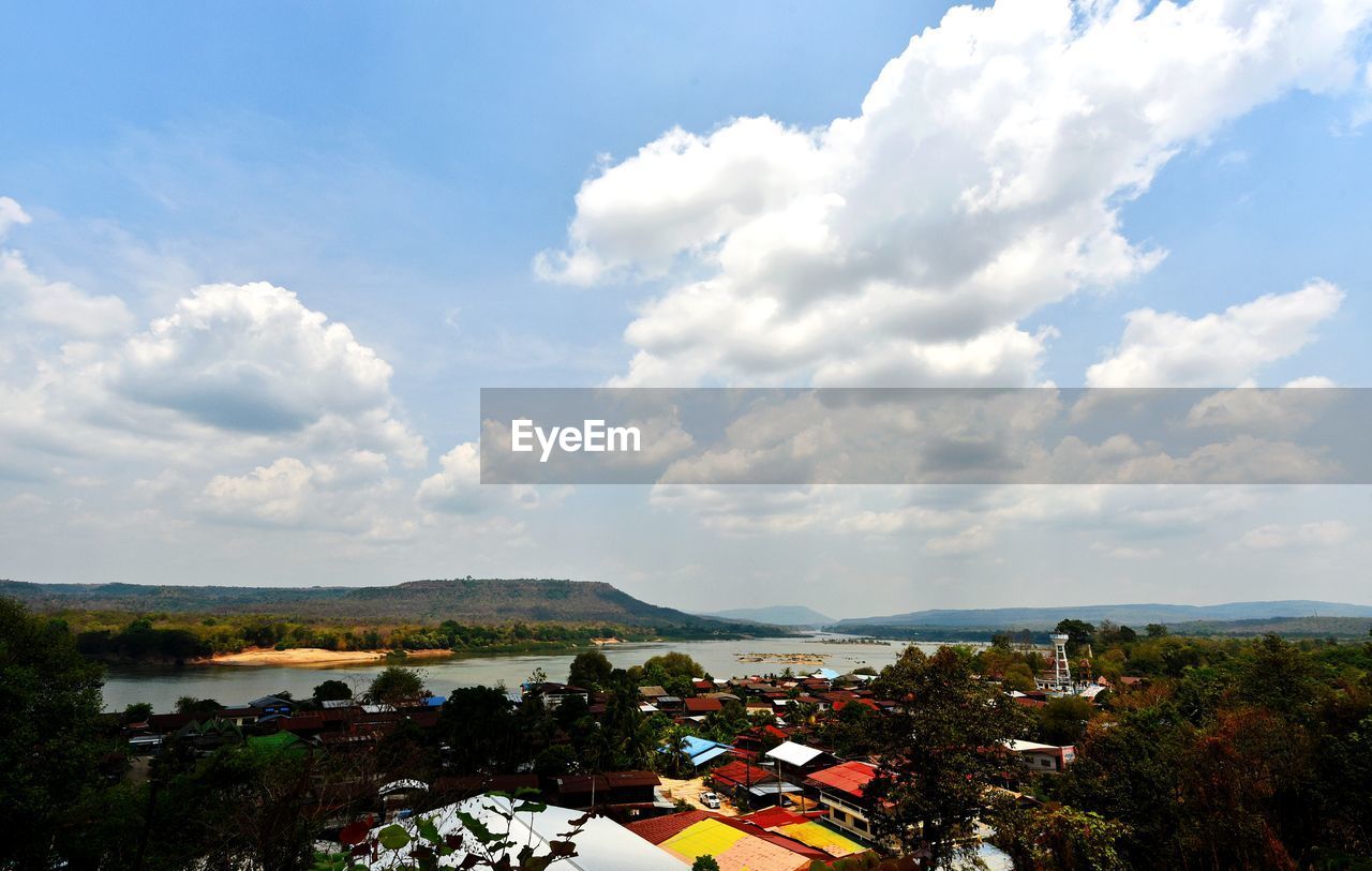 HIGH ANGLE VIEW OF TOWNSCAPE AND TREE AGAINST SKY