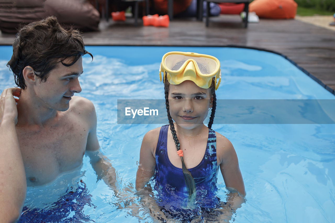 Portrait of smiling girl in swimming pool