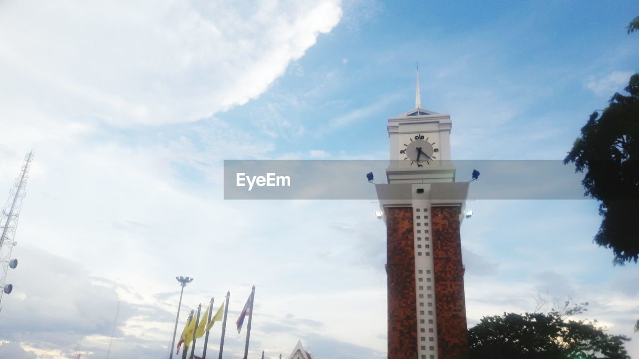 LOW ANGLE VIEW OF CLOCK AGAINST CLOUDY SKY