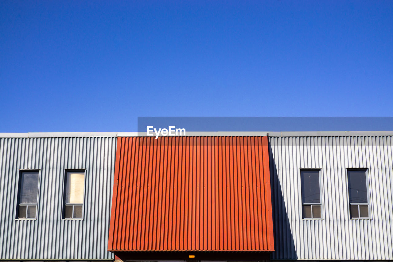 Low angle view of building against clear blue sky