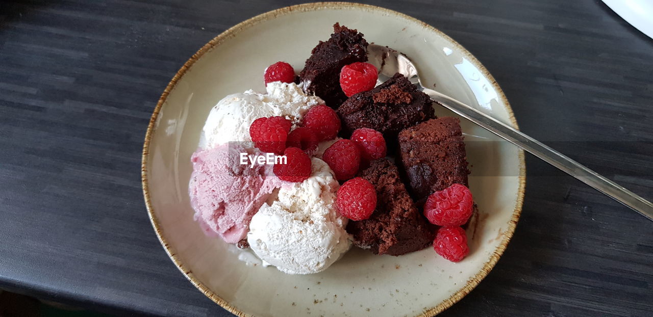 Warm chocolate cake with ice cream and raspberries