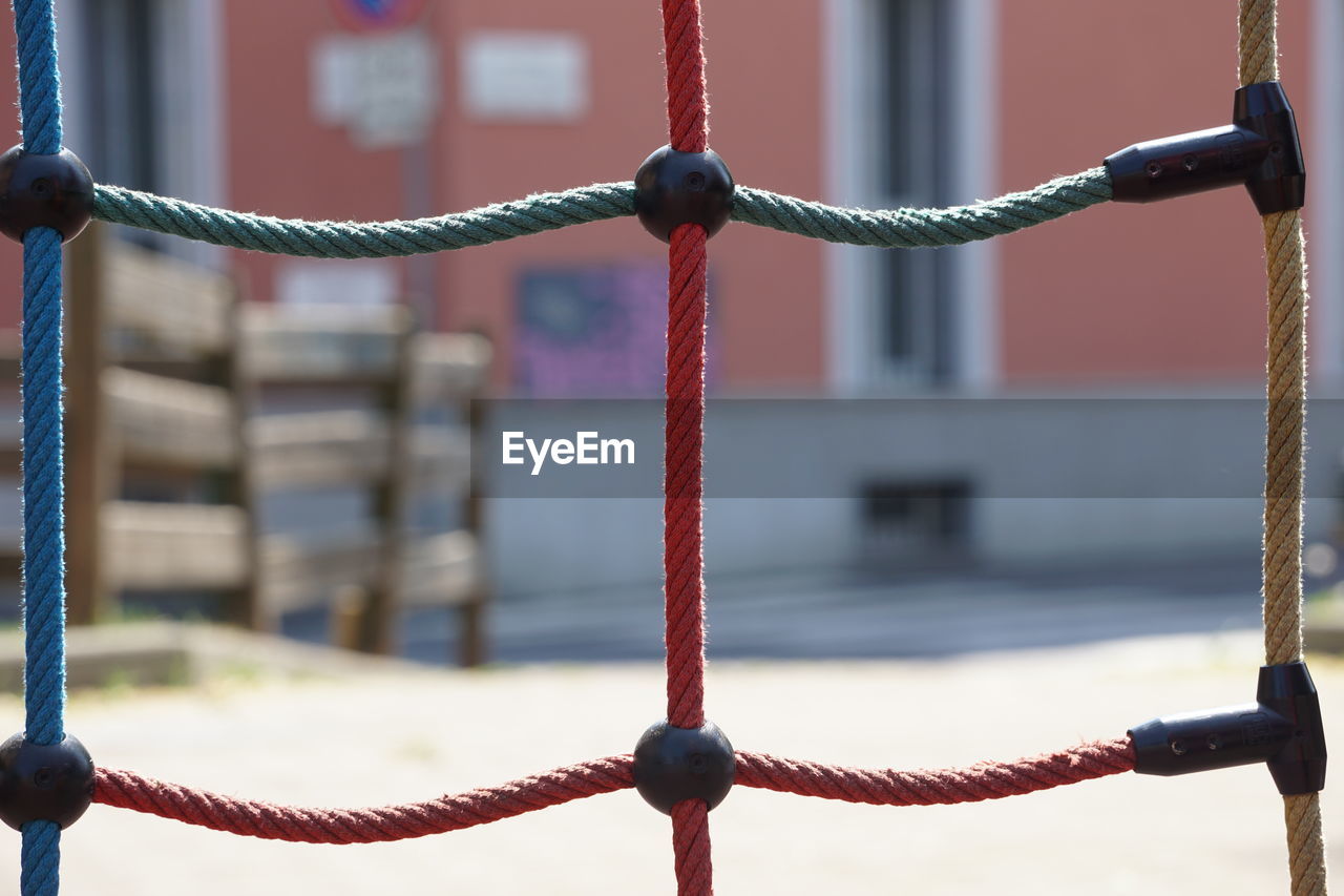 CLOSE-UP OF ROPE TIED UP OF METAL POST