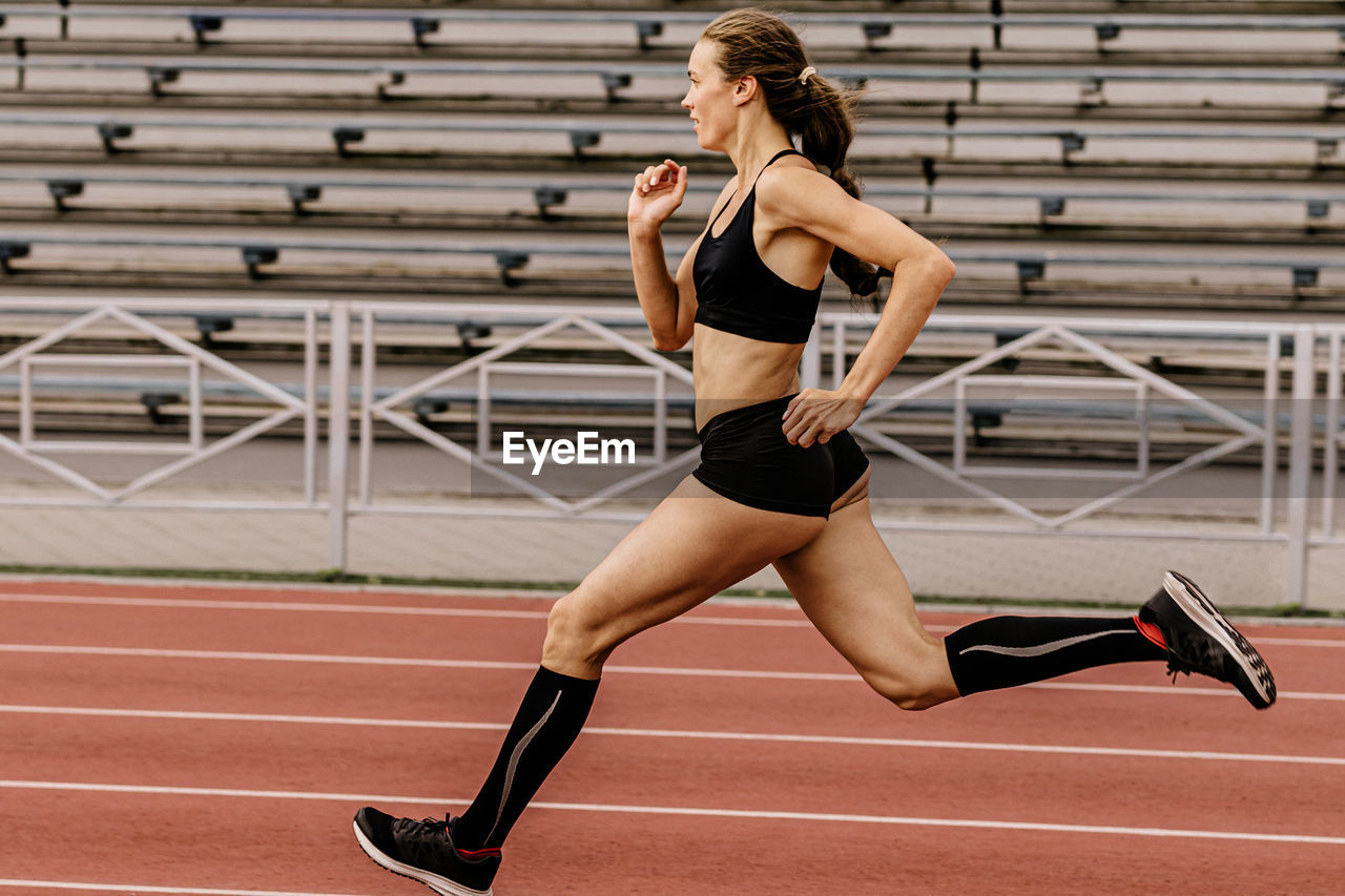 Full length of woman running on track