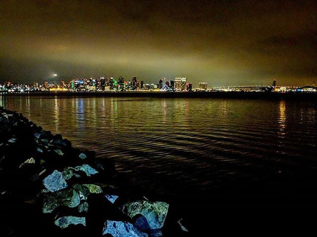 VIEW OF ILLUMINATED CITYSCAPE AT NIGHT