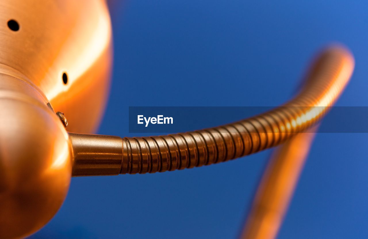 Close-up of metallic object against blue background