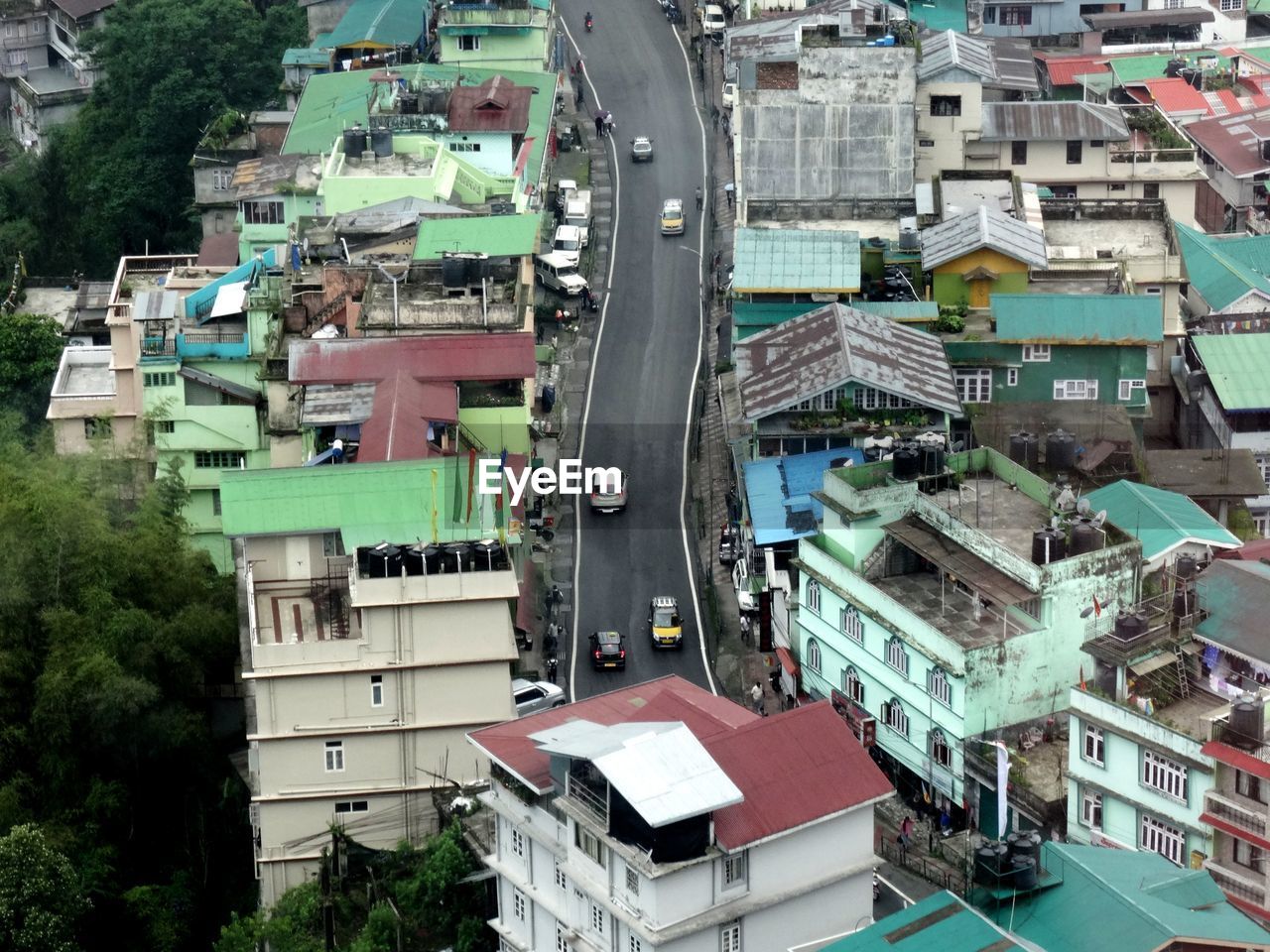 HIGH ANGLE VIEW OF STREET AMIDST BUILDINGS IN CITY