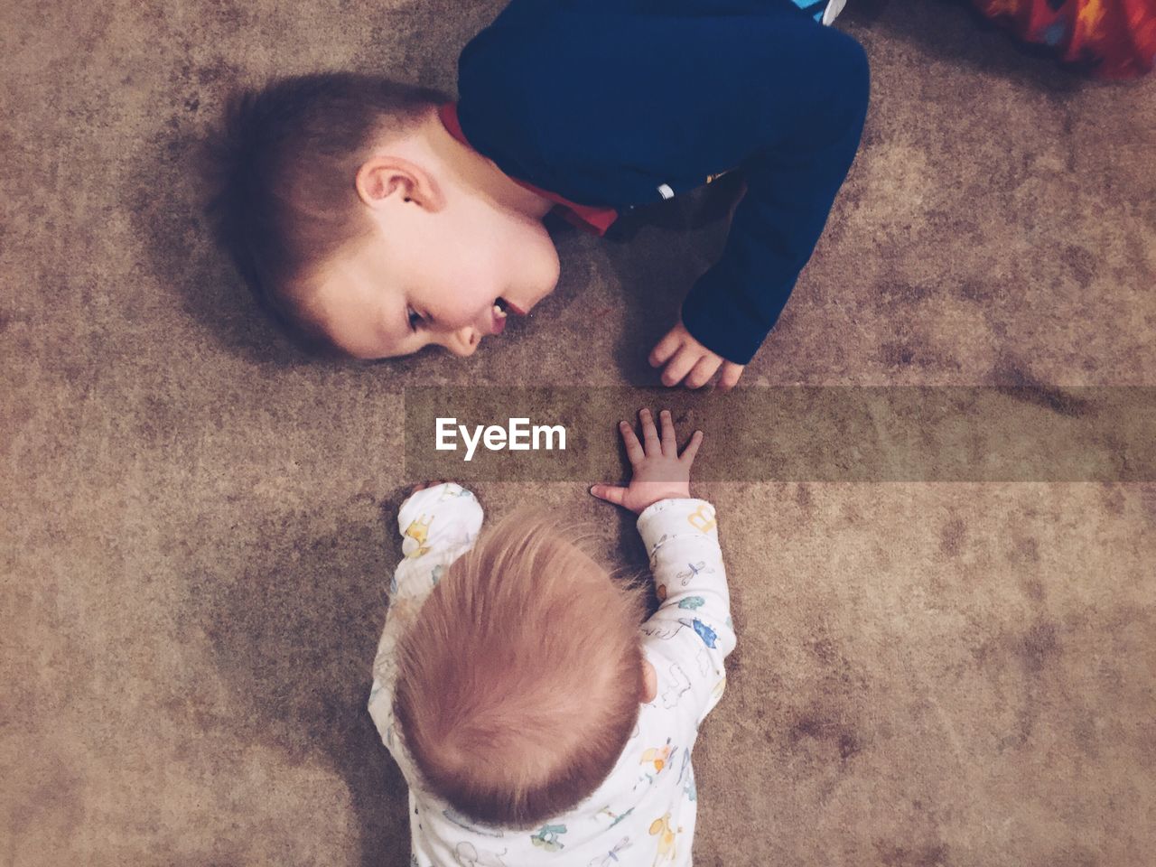 High angle view of sibling playing at home