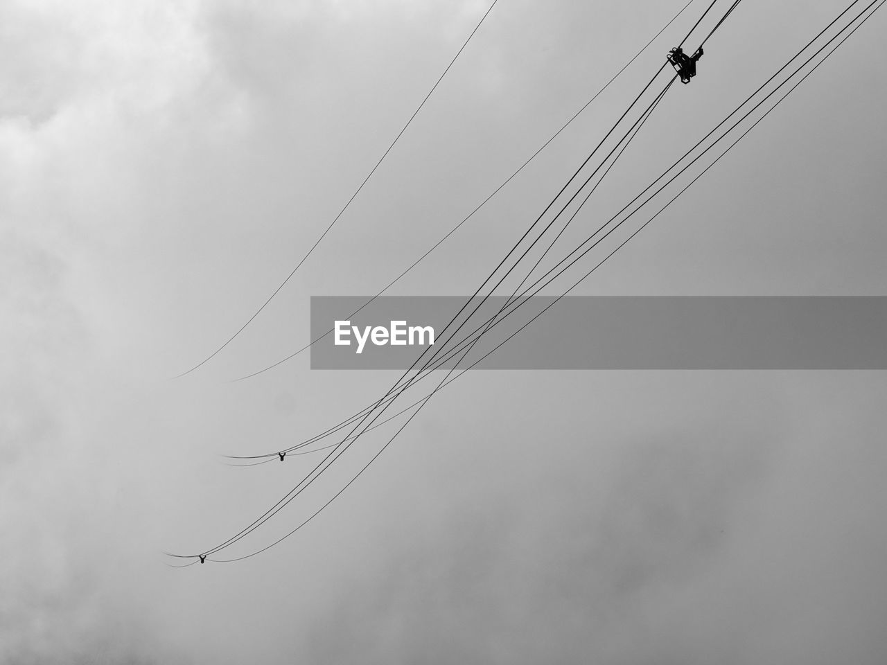 line, sky, cloud, flying, nature, low angle view, cable, animal themes, animal, black and white, no people, wildlife, wing, animal wildlife, monochrome photography, bird, day, outdoors, monochrome, technology, electricity, group of animals, transportation