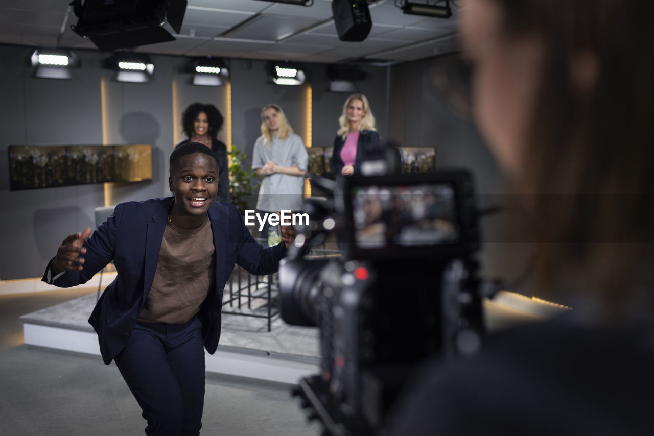 Tv show host and guests in studio