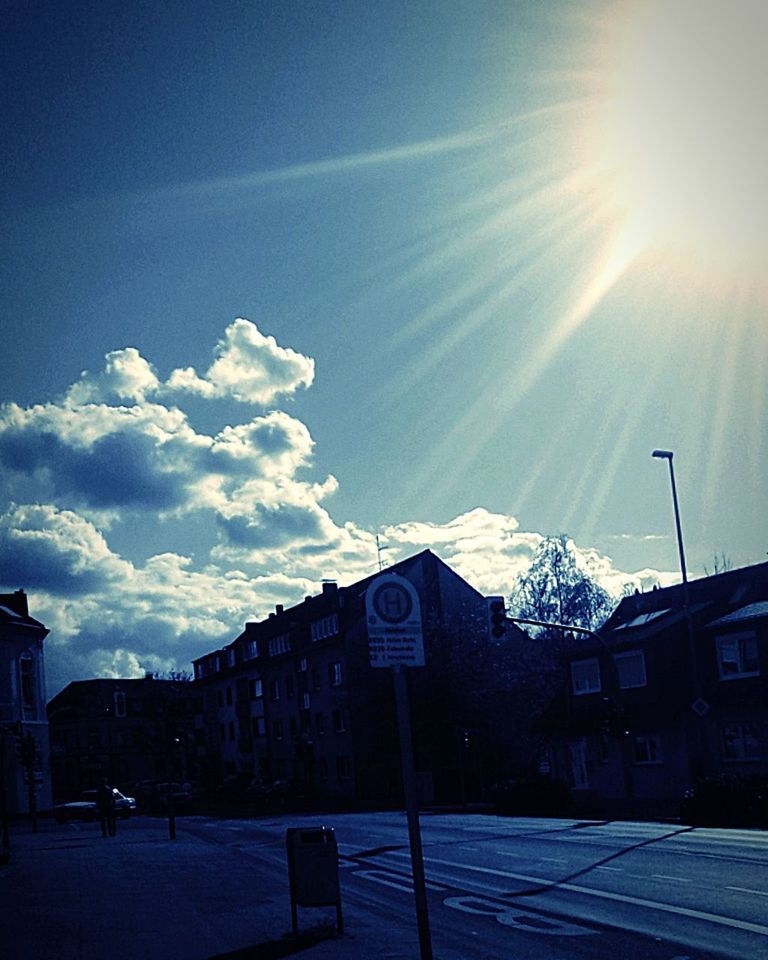 sky, sunlight, evening, architecture, dusk, light, nature, building exterior, built structure, cloud, sun, horizon, sunset, no people, building, sunbeam, city, lens flare, darkness, snow, winter, outdoors, blue, street, house, cold temperature, transportation, reflection