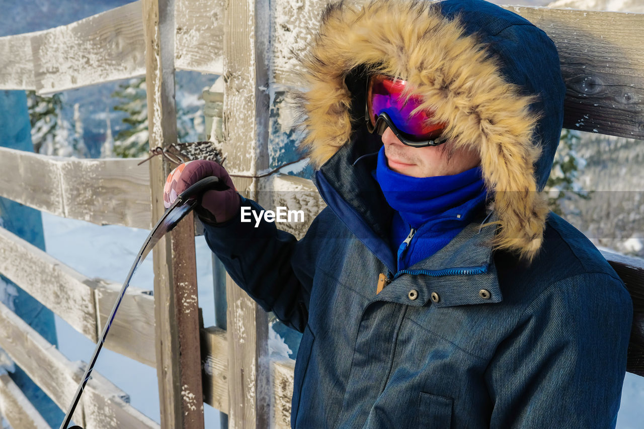 Man wearing warn clothing while standing outdoors during winter