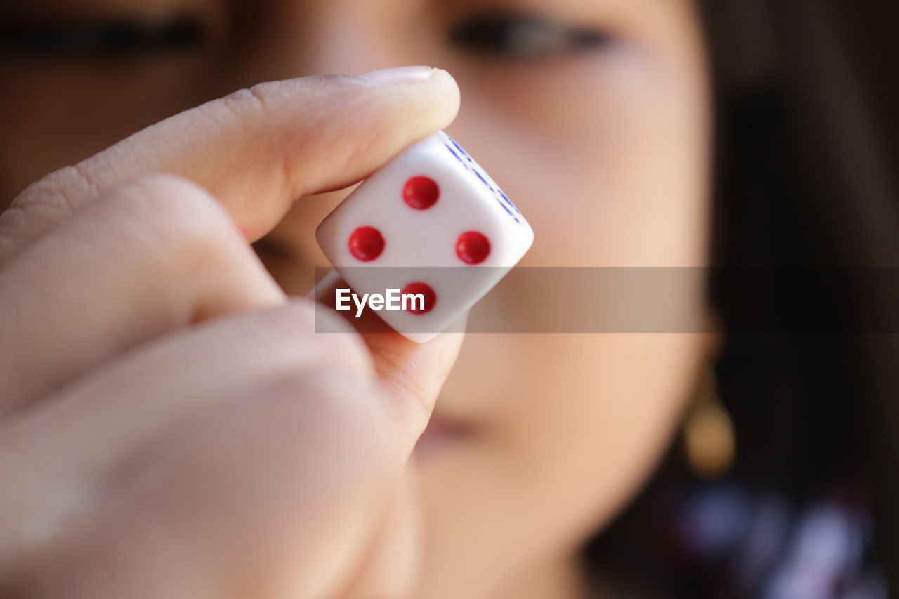 Close-up of girl holding dice