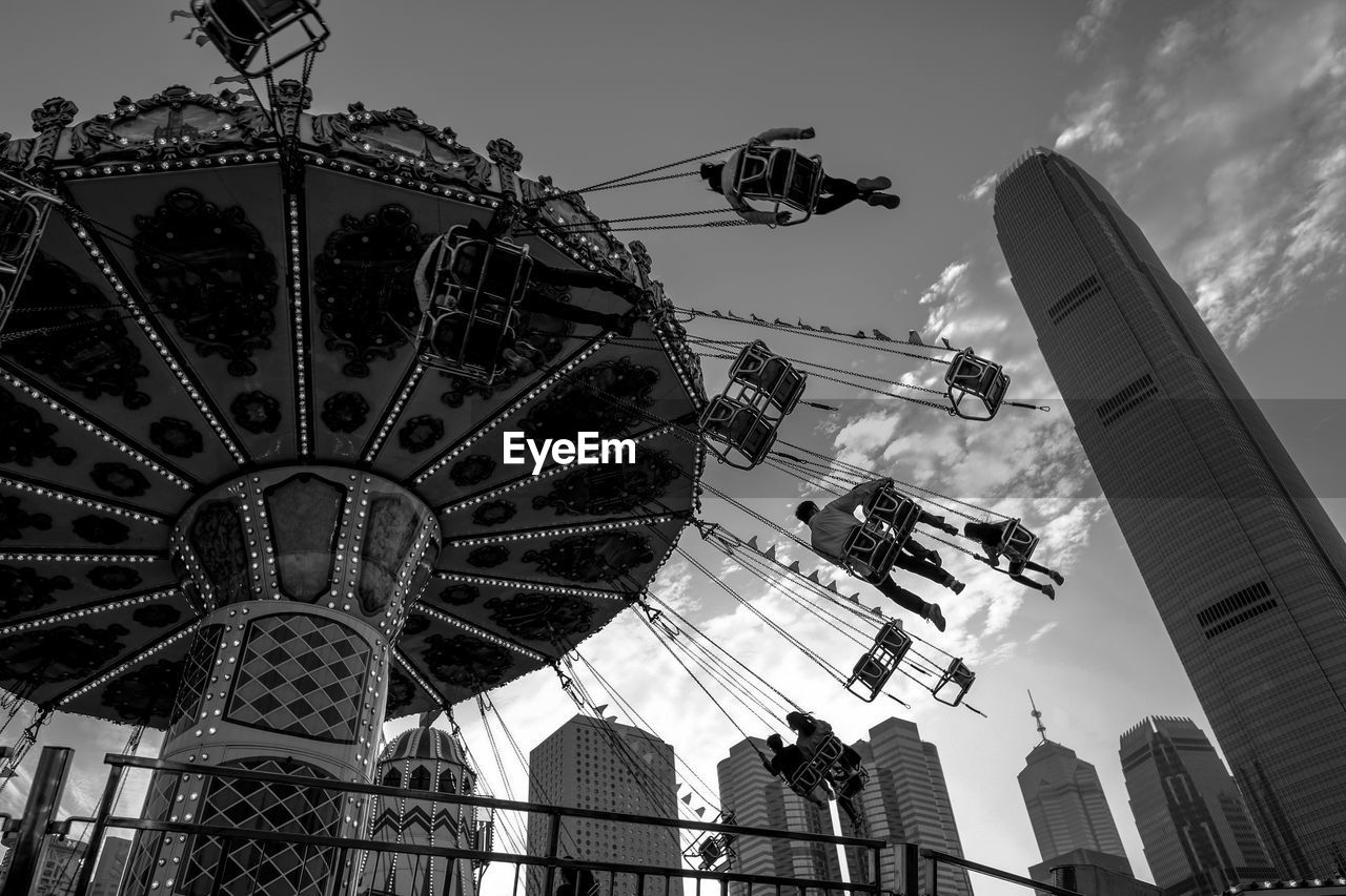 LOW ANGLE VIEW OF ROLLERCOASTER AGAINST SKY