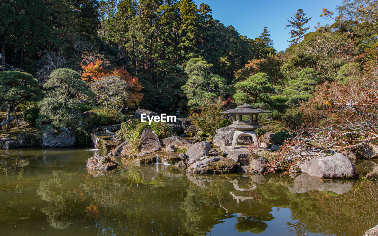 Full frame view of zen garden with reflecting water and autumn fall colors