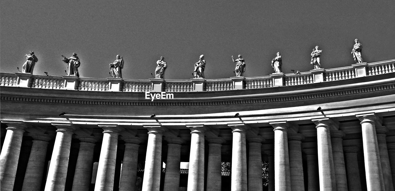Low angle view of statues at st peter basilica against clear sky