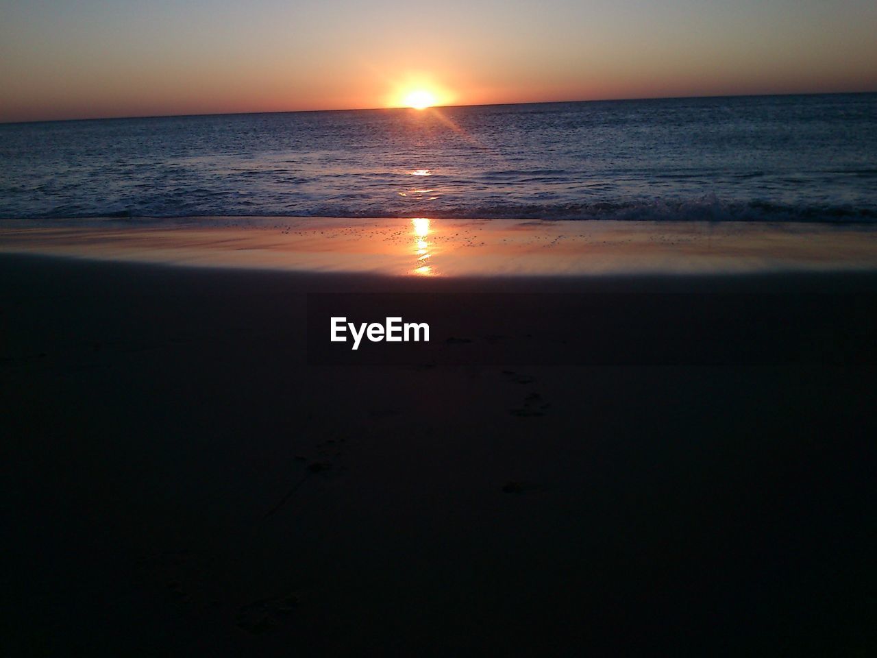 SCENIC VIEW OF BEACH DURING SUNSET