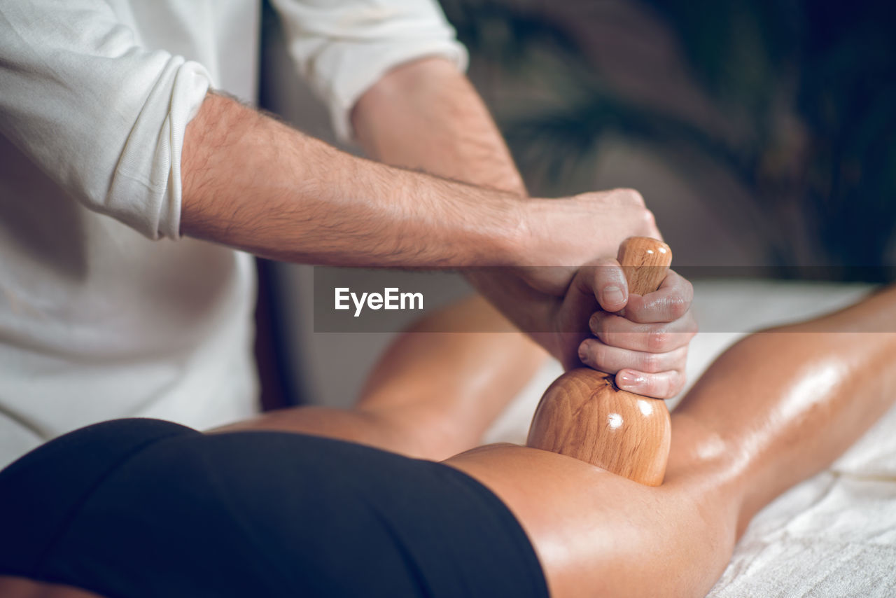 Midsection of man giving massage to woman