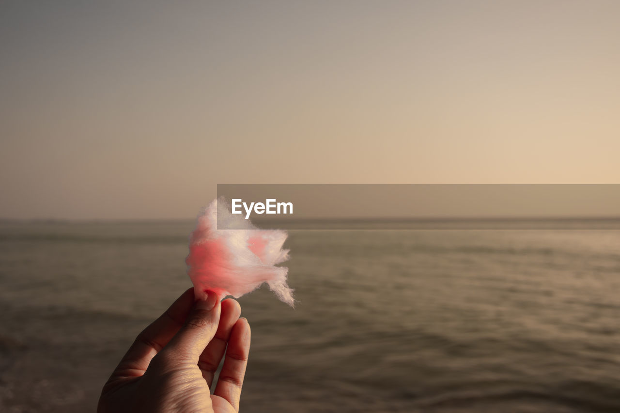 Holding cotton candy on the beach, mae ramphueng beach, rayong, thailand