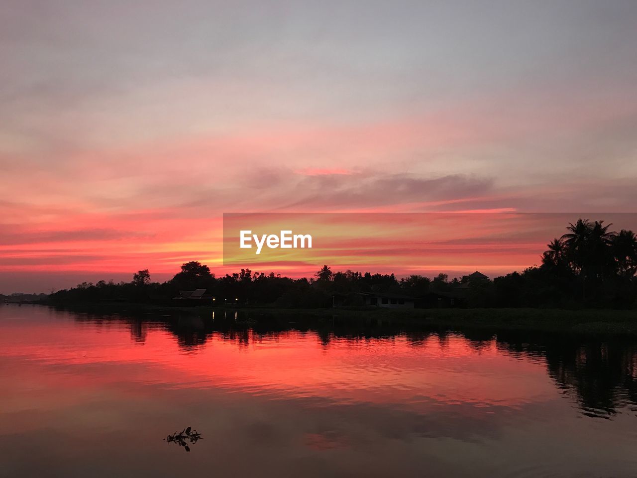 Scenic view of lake against orange sky