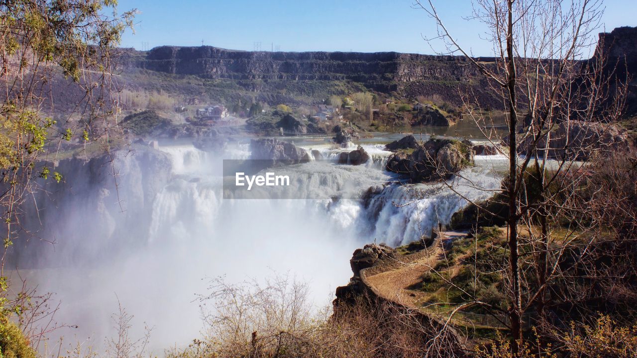 Panoramic view of waterfall against sky