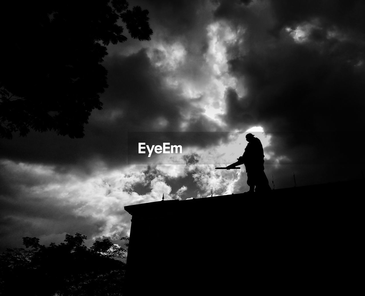 SILHOUETTE MAN STANDING AGAINST SKY AT DUSK