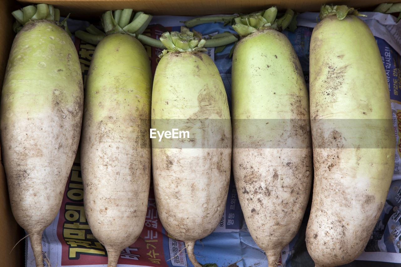 Directly above shot of daikon radish for sale at market stall