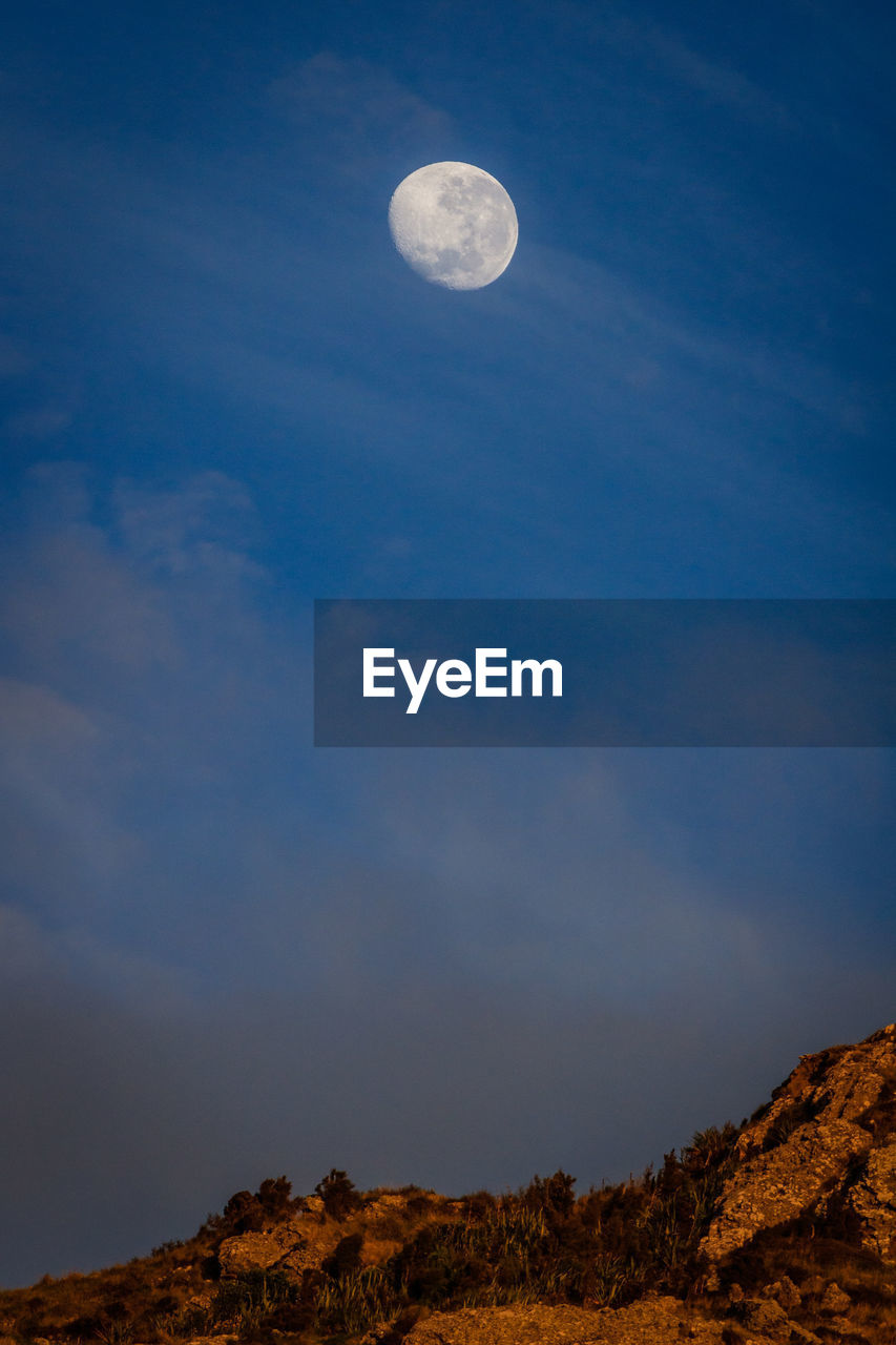 Low angle view of moon against sky at night