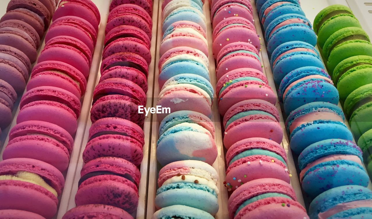 High angle view of multi colored macaroons for sale in shop
