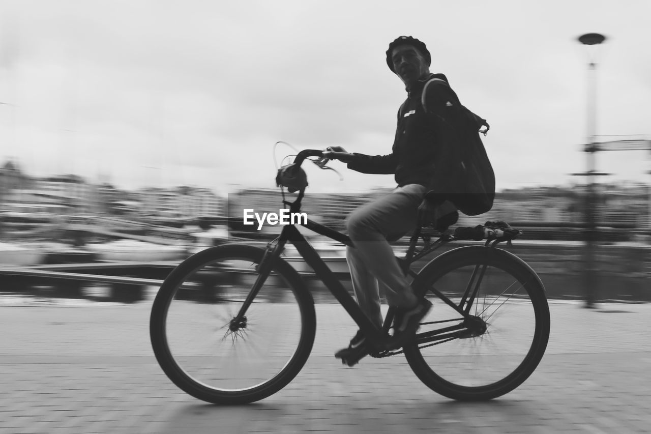 MAN RIDING BICYCLE ON STREET