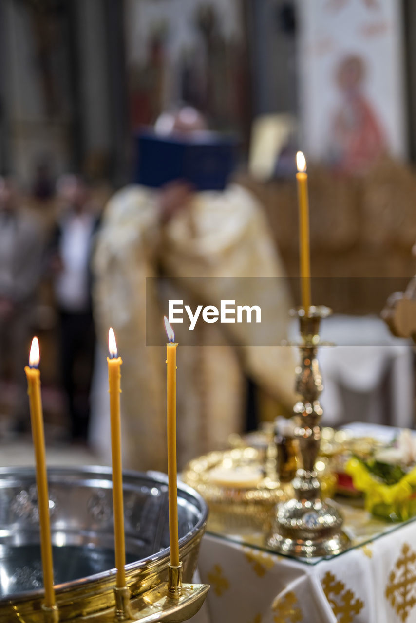 close-up of lit candles on table