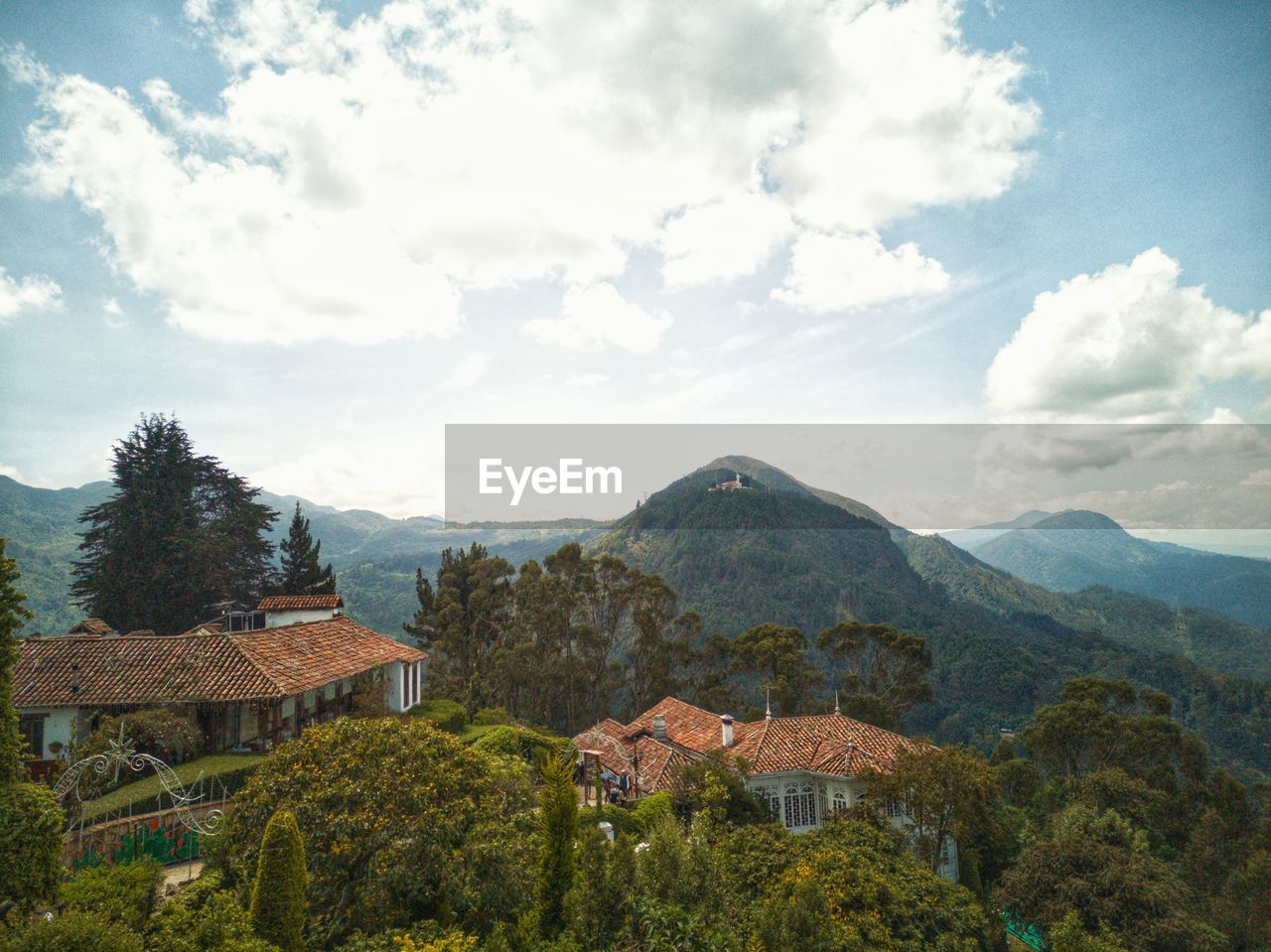 Panoramic view of houses and mountains against sky