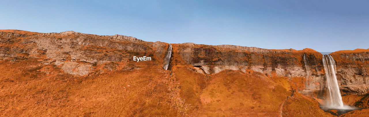 ROCK FORMATIONS ON MOUNTAIN AGAINST SKY