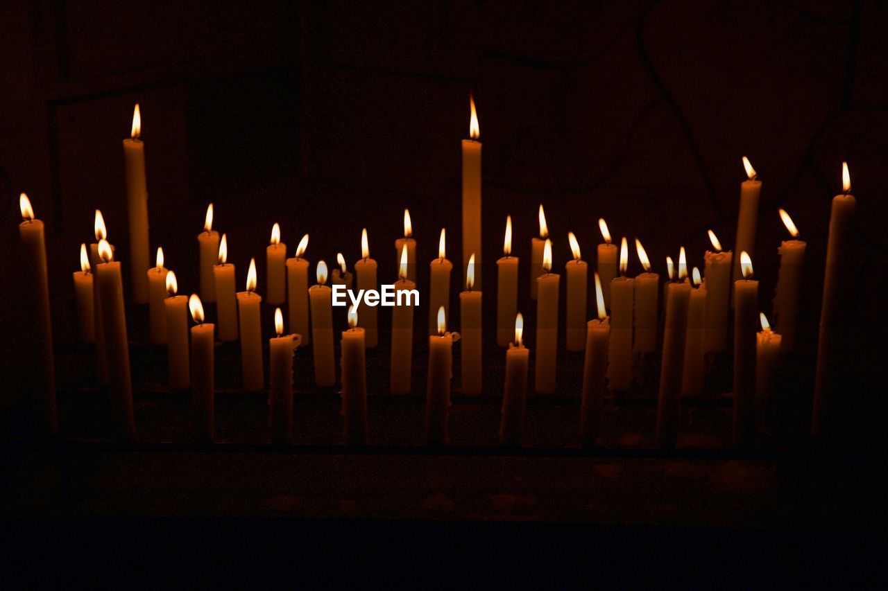 Close-up of lit candles in temple