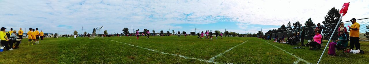 CROWD ON GRASSY FIELD AGAINST SKY